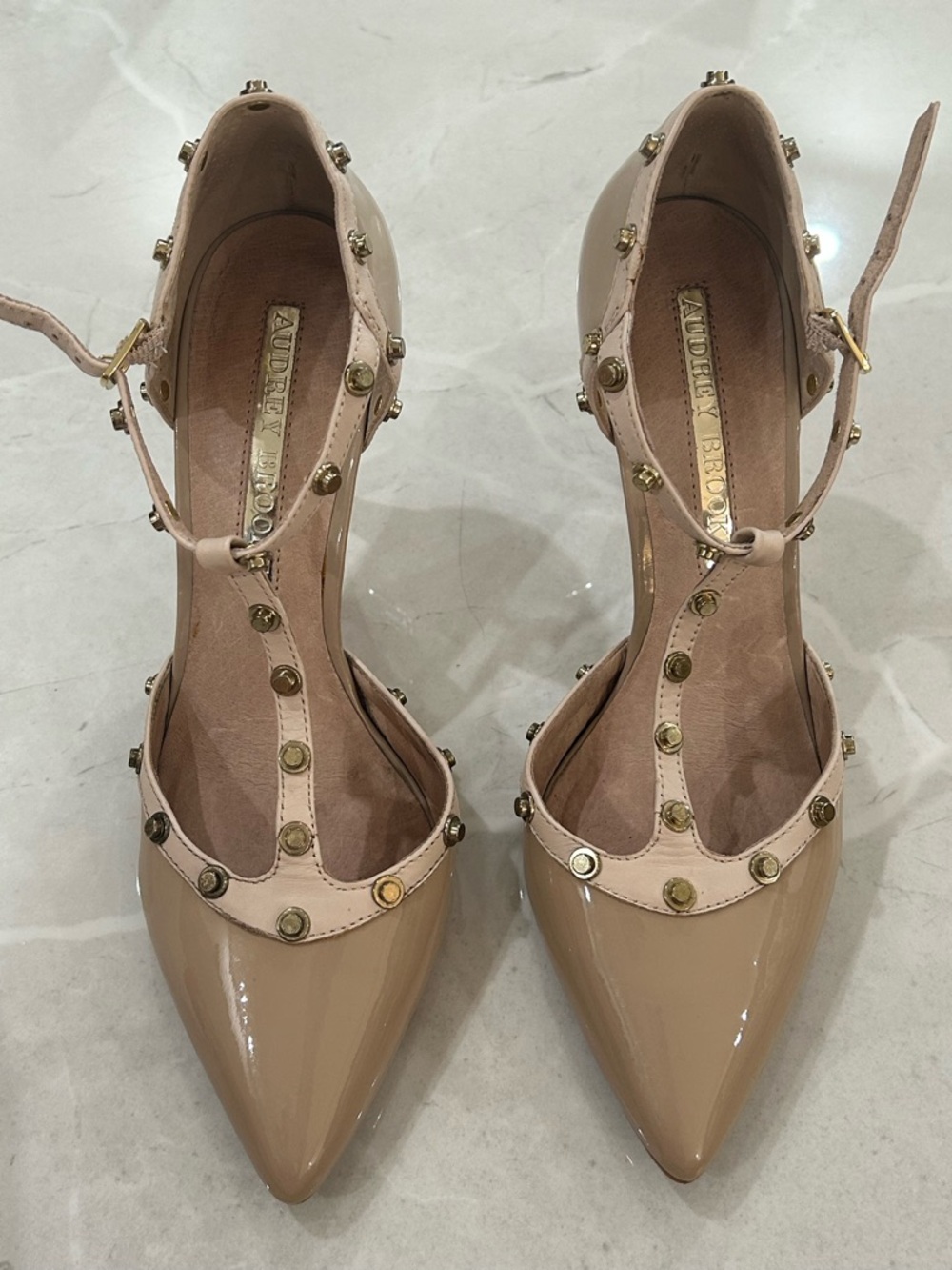 Audrey Brooke Nude Patent Pointed T-Strap Heels with Gold Studs